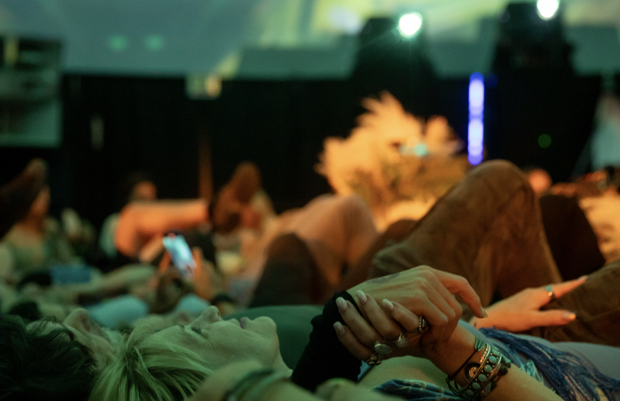 Intimate audience close-up — hands clasped during ceremony